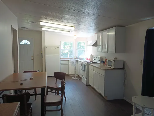 a kitchen with sink cabinets and dining table