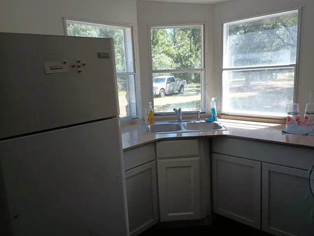 a kitchen with a sink and a refrigerator
