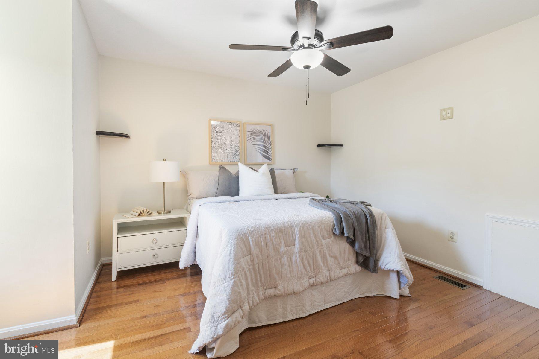 14215 Greenview Drive Laurel, MD 20708 - Photo 24 of 35 a bedroom with a bed and a chandelier