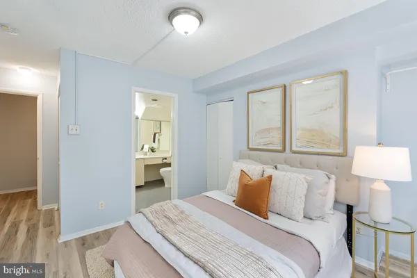 a bedroom with a bed and a lamp