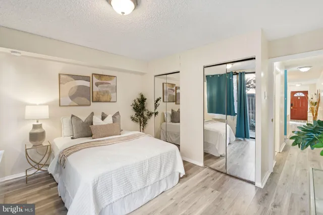 a bedroom with a bed and a potted plant