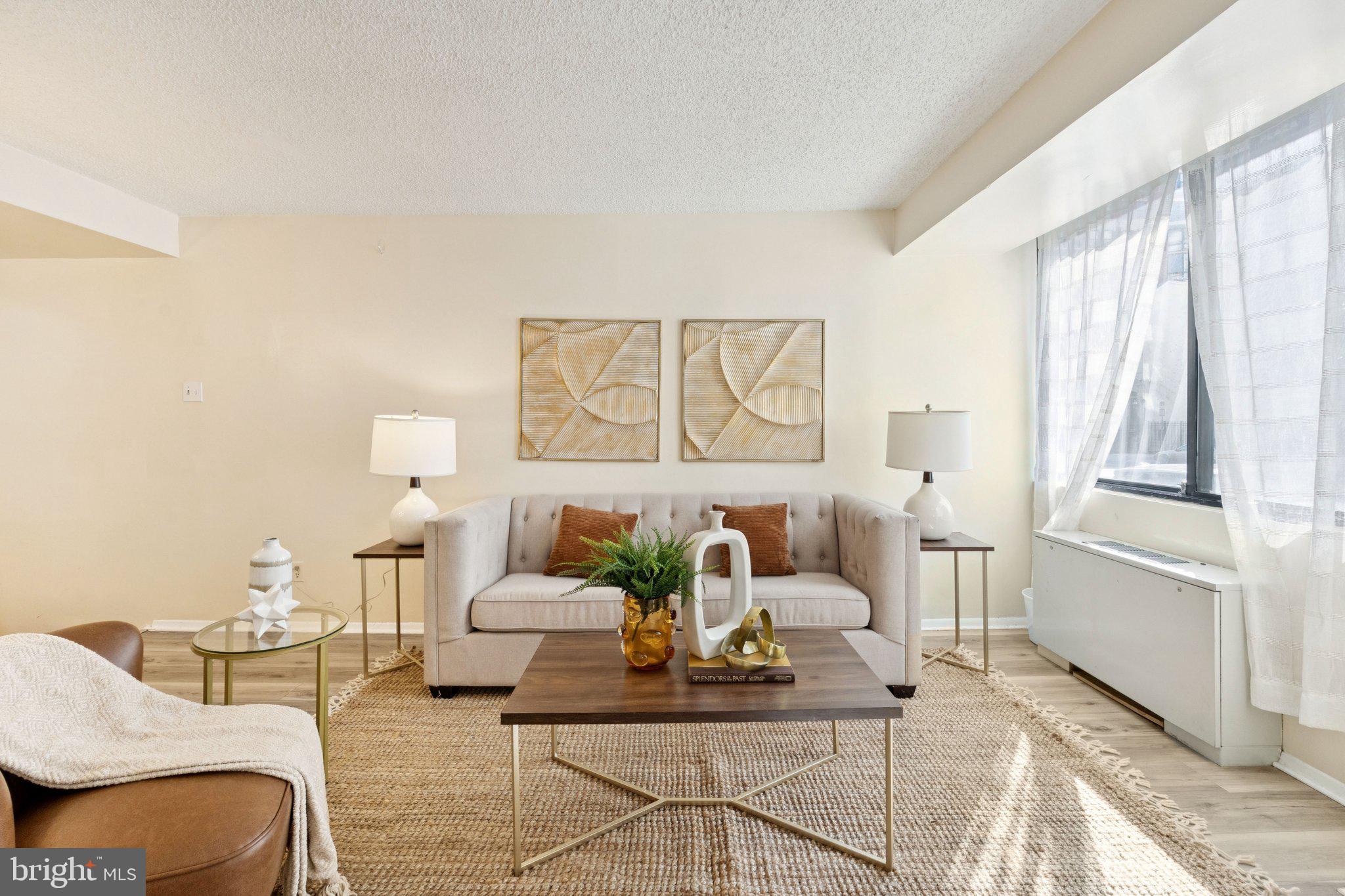 1245 13th Street Northwest, Unit 109 Washington, DC 20005 - Photo 3 of 25 a living room with furniture and a large window