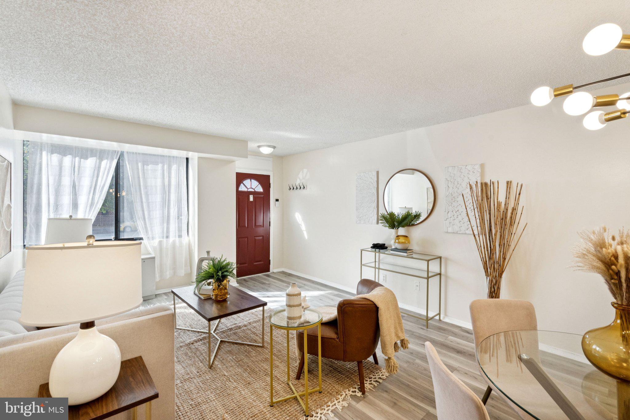 1245 13th Street Northwest, Unit 109 Washington, DC 20005 - Photo 4 of 25 a living room with furniture and a large window