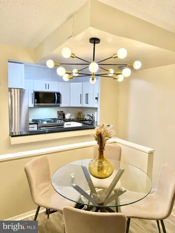 a kitchen with a dining table and chairs