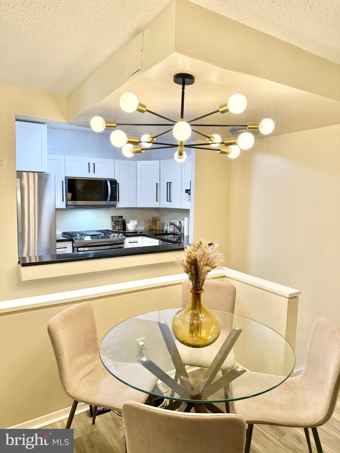 1245 13th Street Northwest, Unit 109 Washington, DC 20005 - Photo 7 of 25 a kitchen with a dining table and chairs