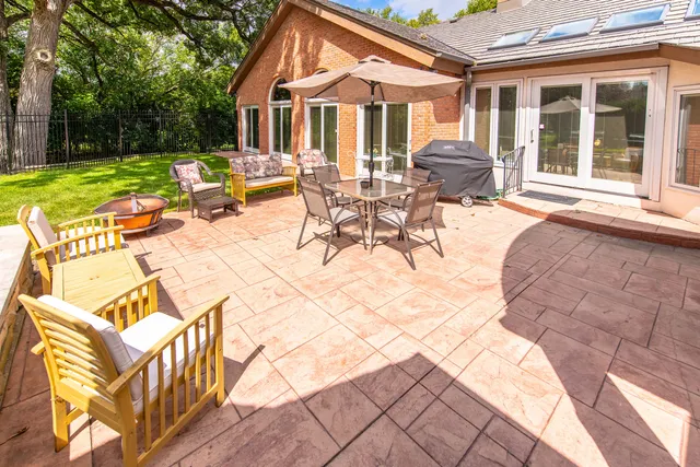 a spacious bedroom with a bed and a chandelier