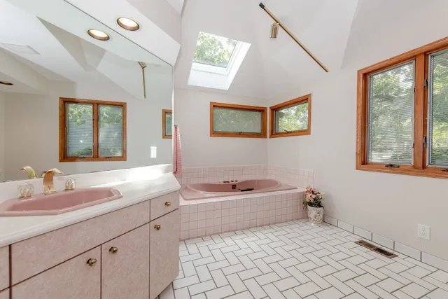 a large bed sitting in a bedroom next to a window