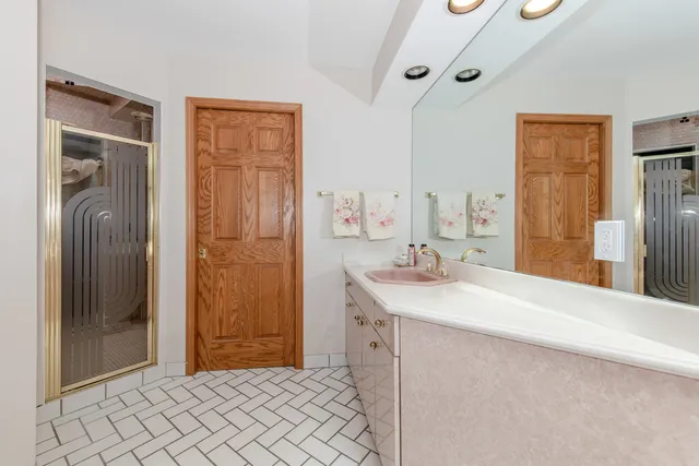 a bedroom with a large bed and a flat tv screen