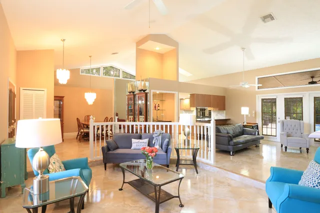 a kitchen with stainless steel appliances granite countertop a sink a stove and a refrigerator