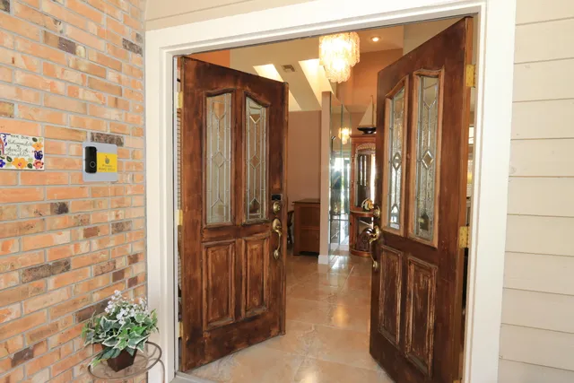 a living room with furniture a fireplace and a large window