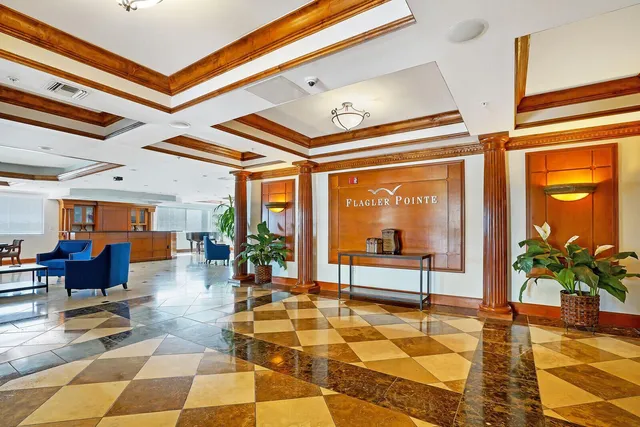 a lobby with furniture and floor to ceiling window
