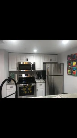 a kitchen with a sink a stove and refrigerator