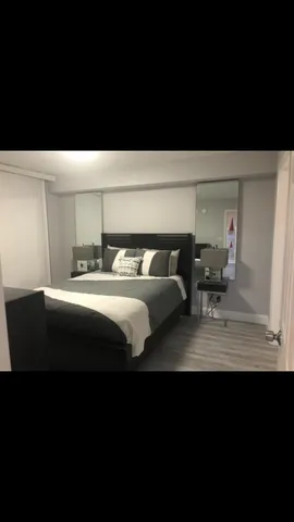 a balcony with lamp on table and chairs