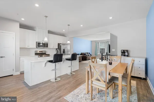 a view of a dining room with furniture and wooden floor