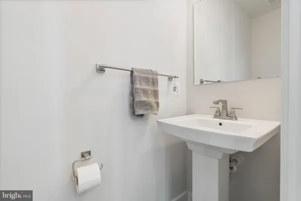a bathroom with a sink a mirror and a toilet