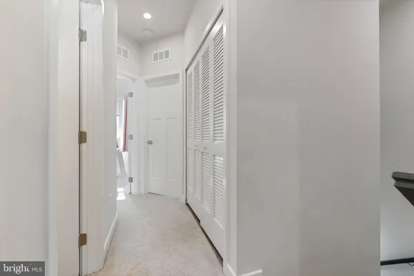 a view of a hallway with wooden shelves