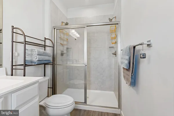 a bathroom with a shower a toilet and a shower