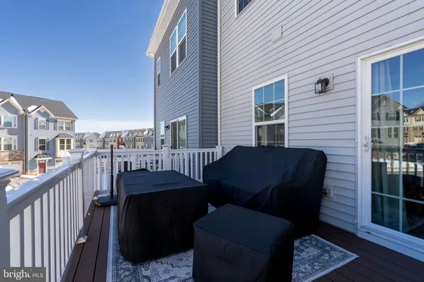 a view of a porch with furniture and garden