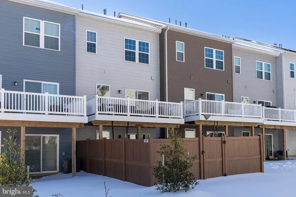 a front view of residential houses with yard and green space