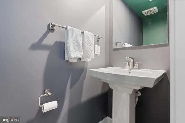 a bathroom with a sink and mirror