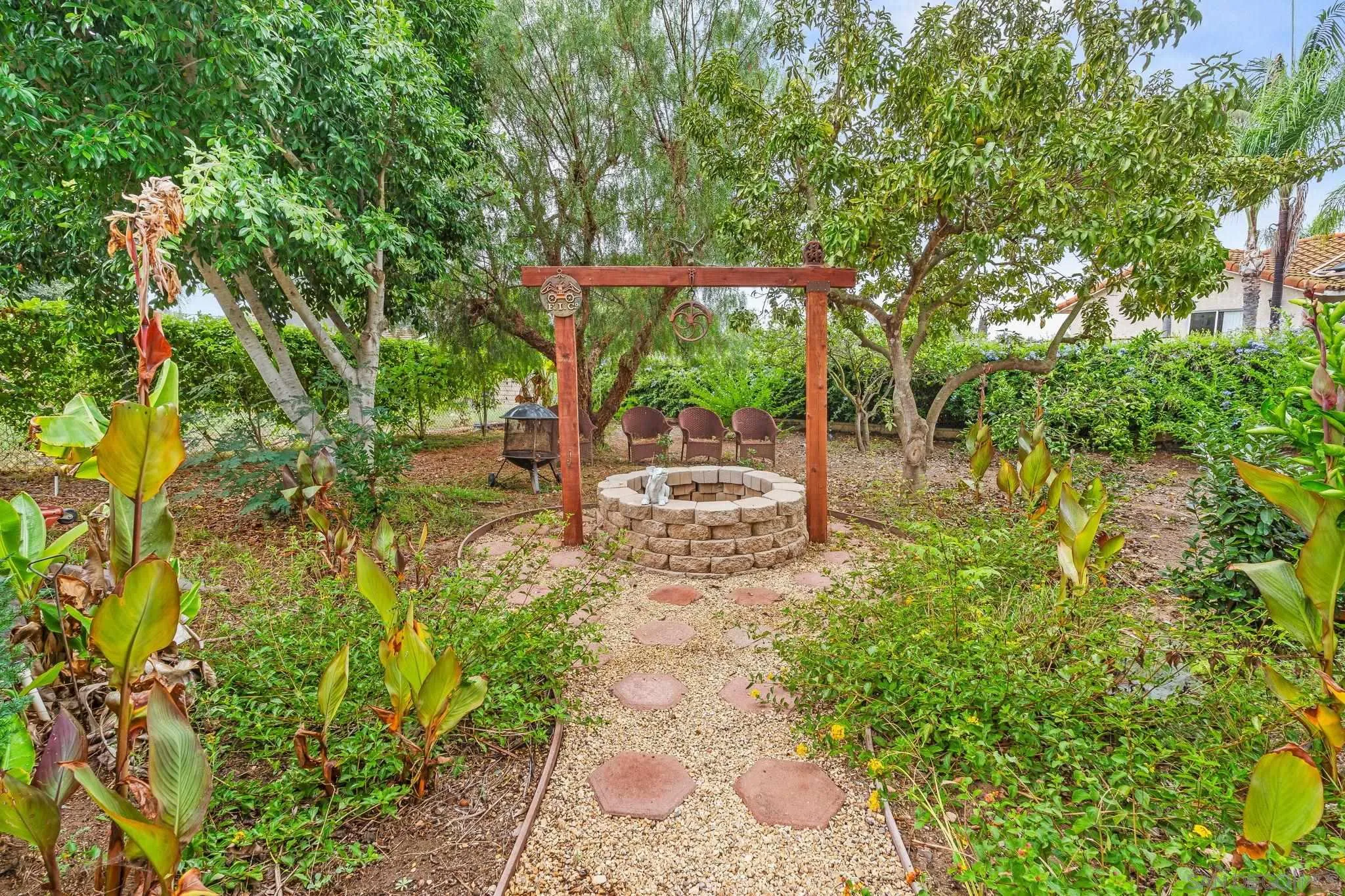 1451 Vía Lima Fallbrook, CA 92028 - Photo 11 of 41 a lawn chair sitting in a yard with large trees