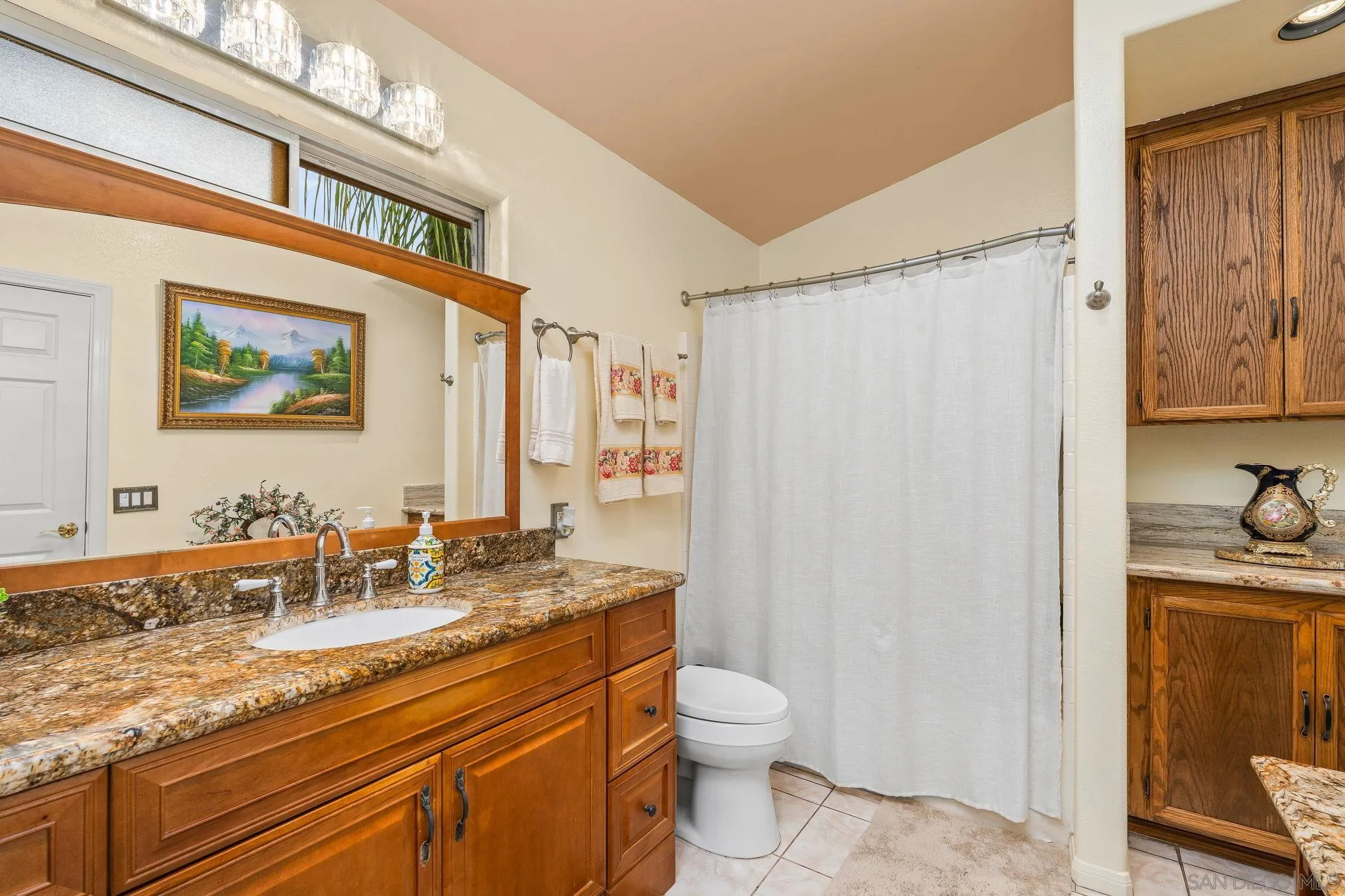 1451 Vía Lima Fallbrook, CA 92028 - Photo 17 of 41 a bathroom with a granite countertop sink a toilet and shower