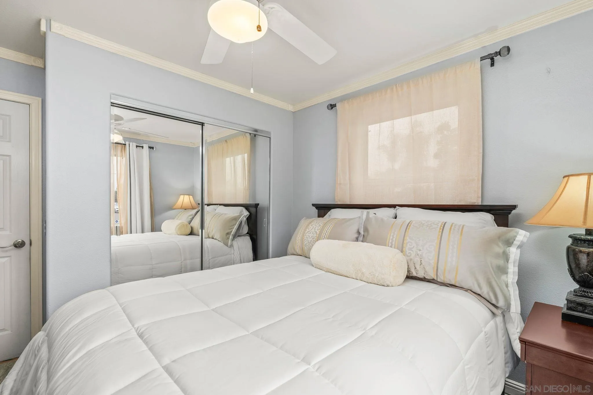 1451 Vía Lima Fallbrook, CA 92028 - Photo 20 of 41 a bedroom with a large bed and a chandelier