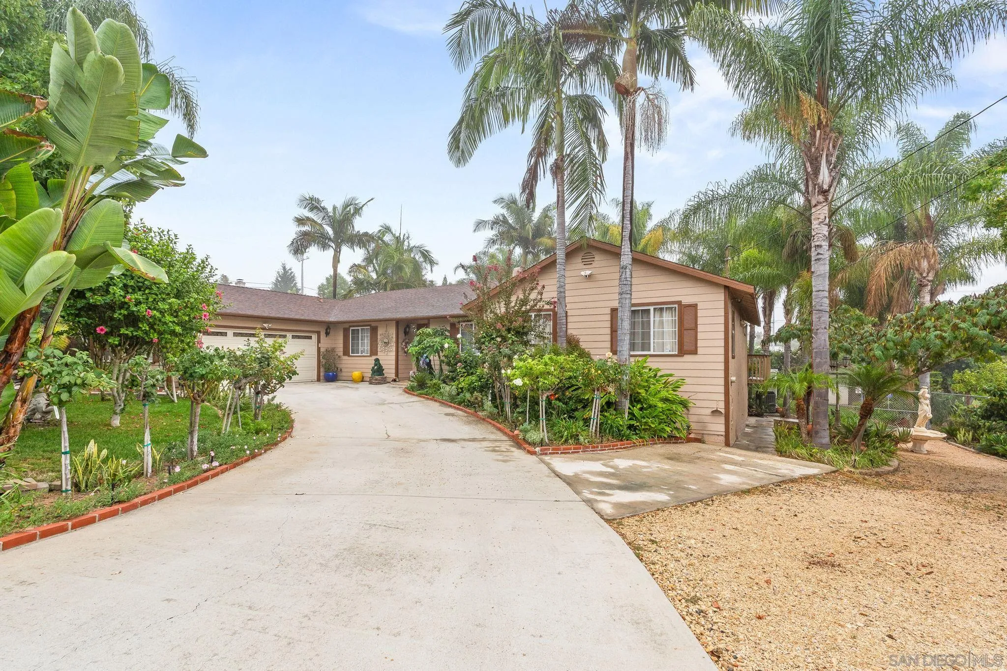 1451 Vía Lima Fallbrook, CA 92028 - Photo 2 of 41 a front view of a house with a garden