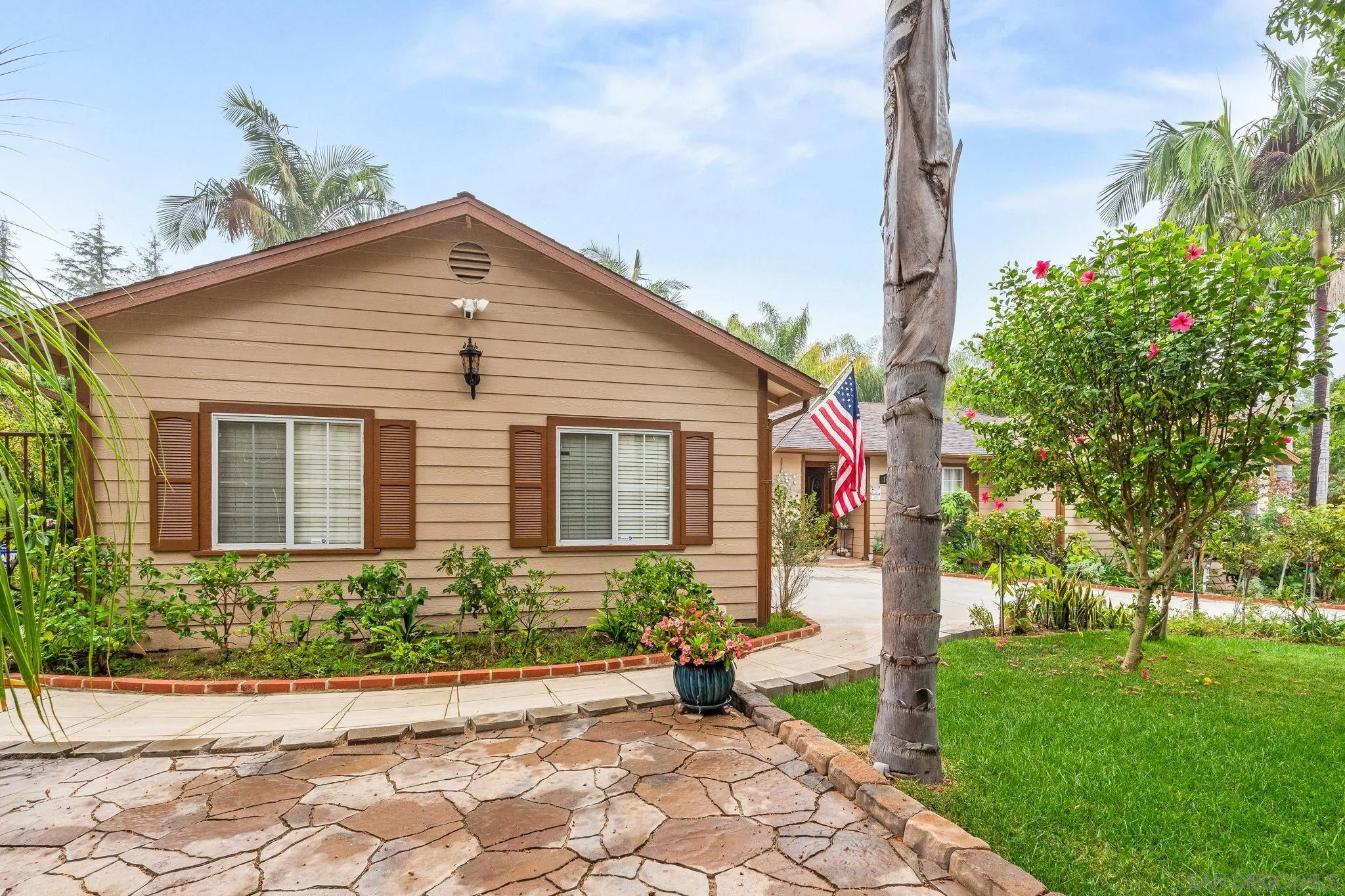 1451 Vía Lima Fallbrook, CA 92028 - Photo 3 of 41 a front view of a house with garden