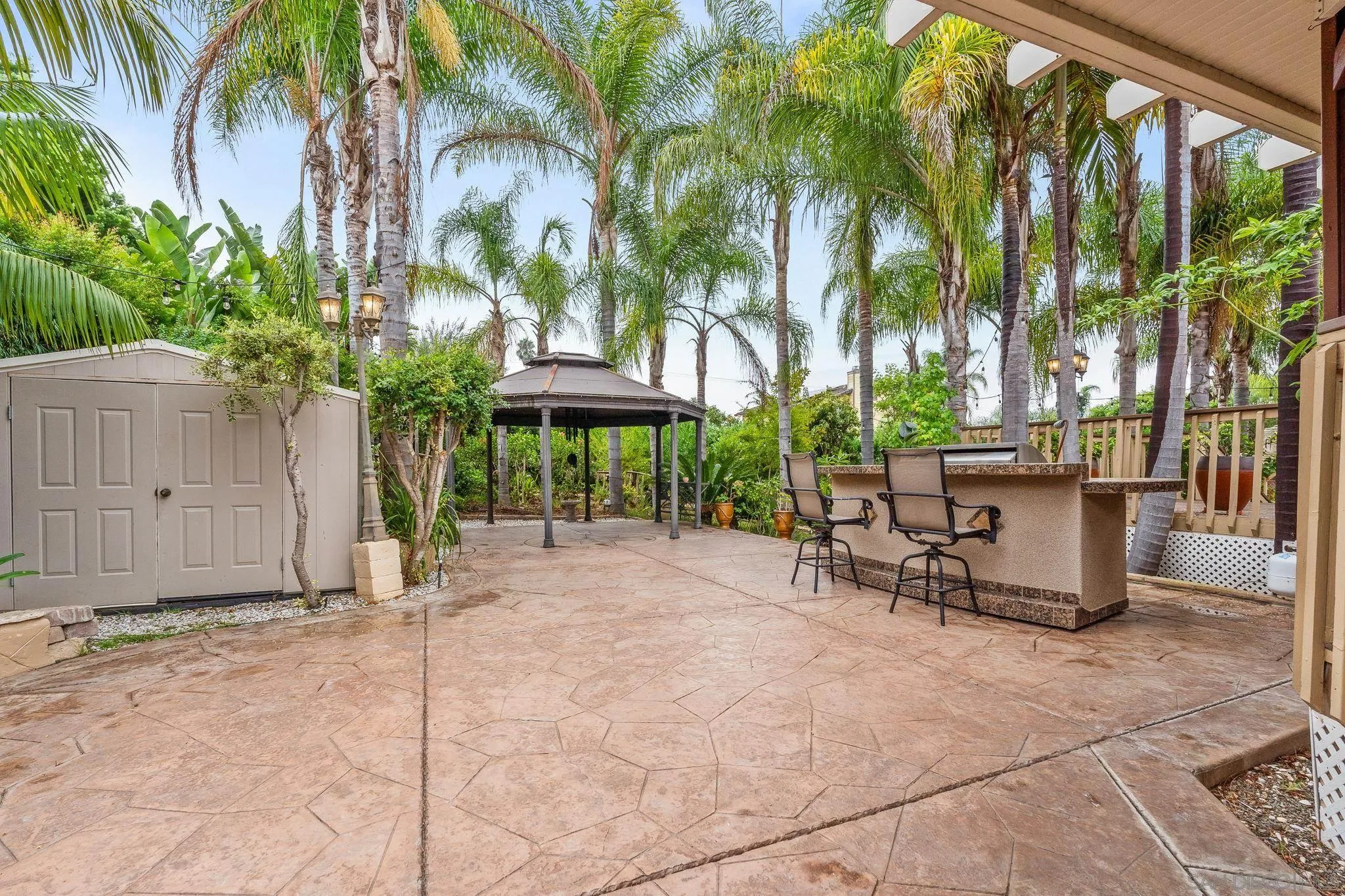 1451 Vía Lima Fallbrook, CA 92028 - Photo 9 of 41 a view of a patio with a table and chairs under an umbrella