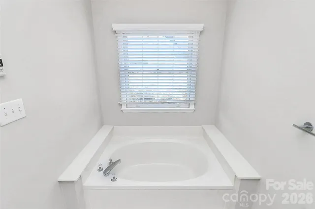 a white bath tub sitting next to a window