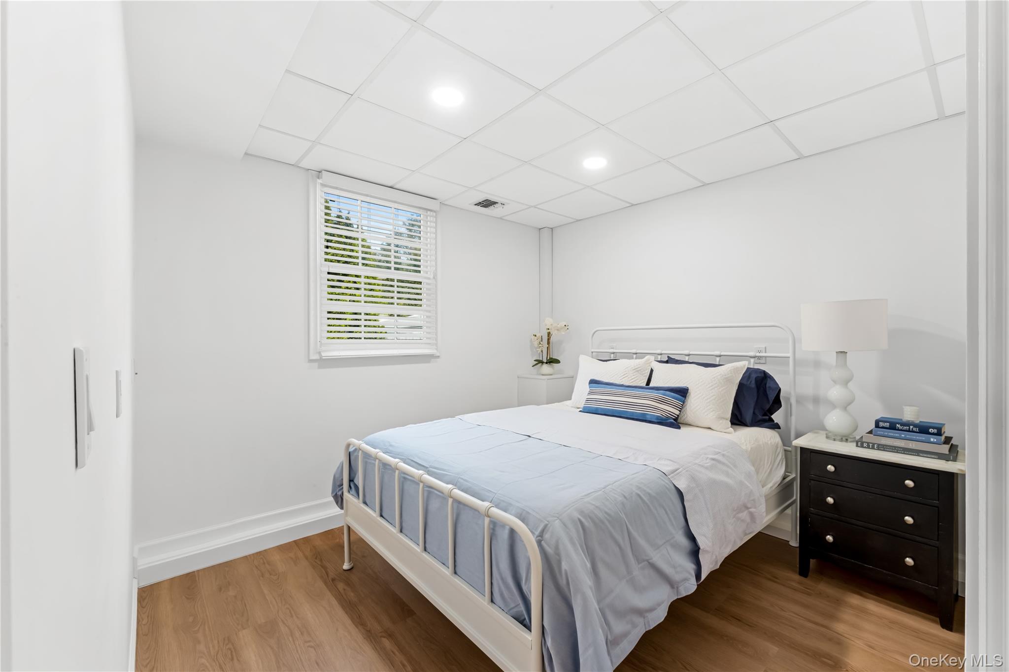 22 Delaware Avenue Jericho, NY 11753 - Photo 16 of 35 a bedroom with a bed and a window