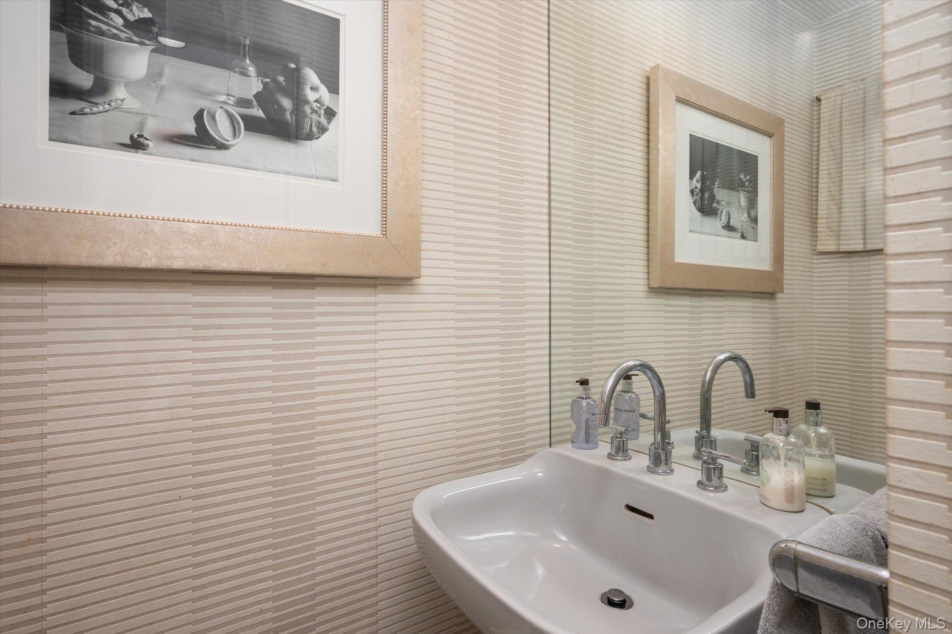 22 Delaware Avenue Jericho, NY 11753 - Photo 29 of 35 a bathroom with a sink and a mirror