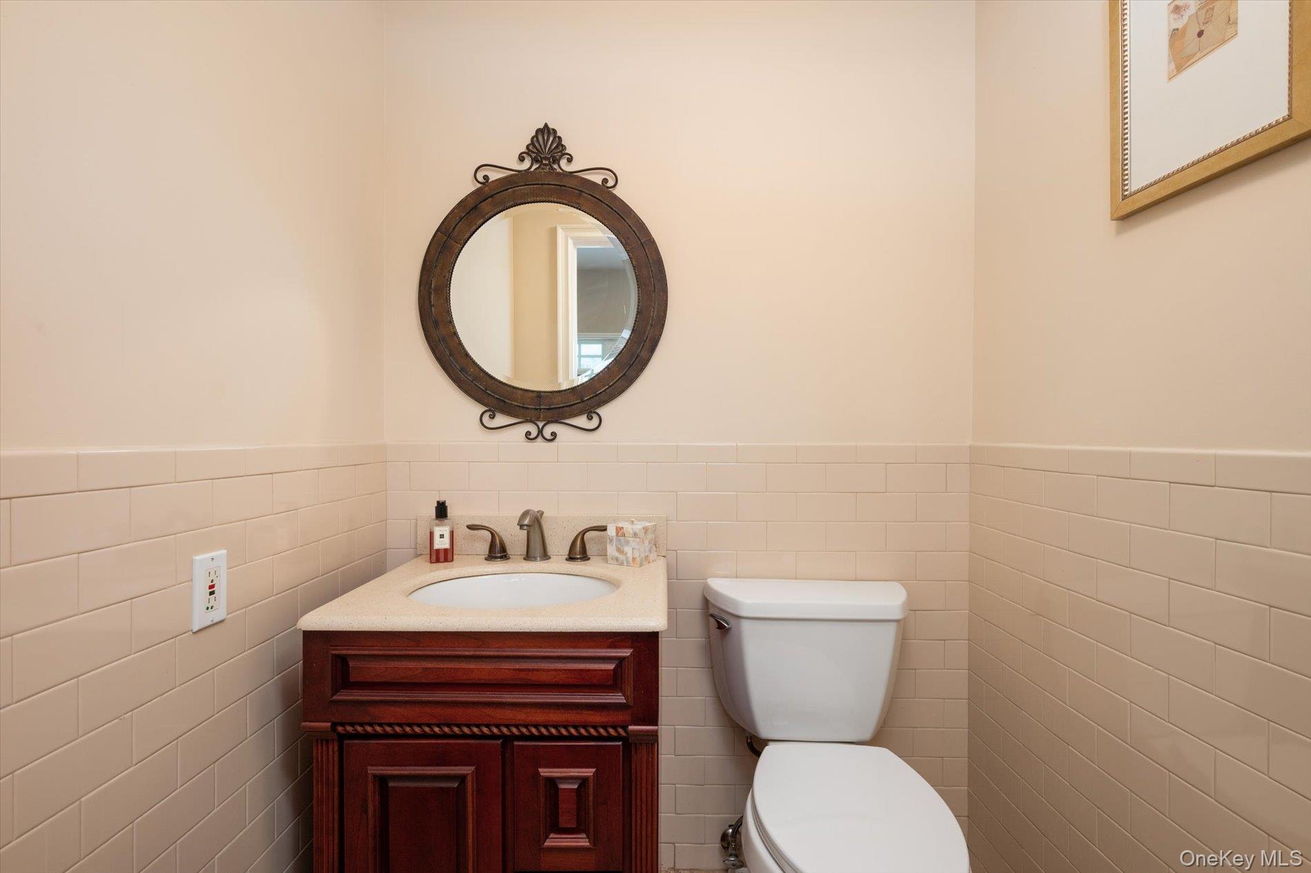22 Delaware Avenue Jericho, NY 11753 - Photo 30 of 35 a bathroom with a toilet a sink and a mirror
