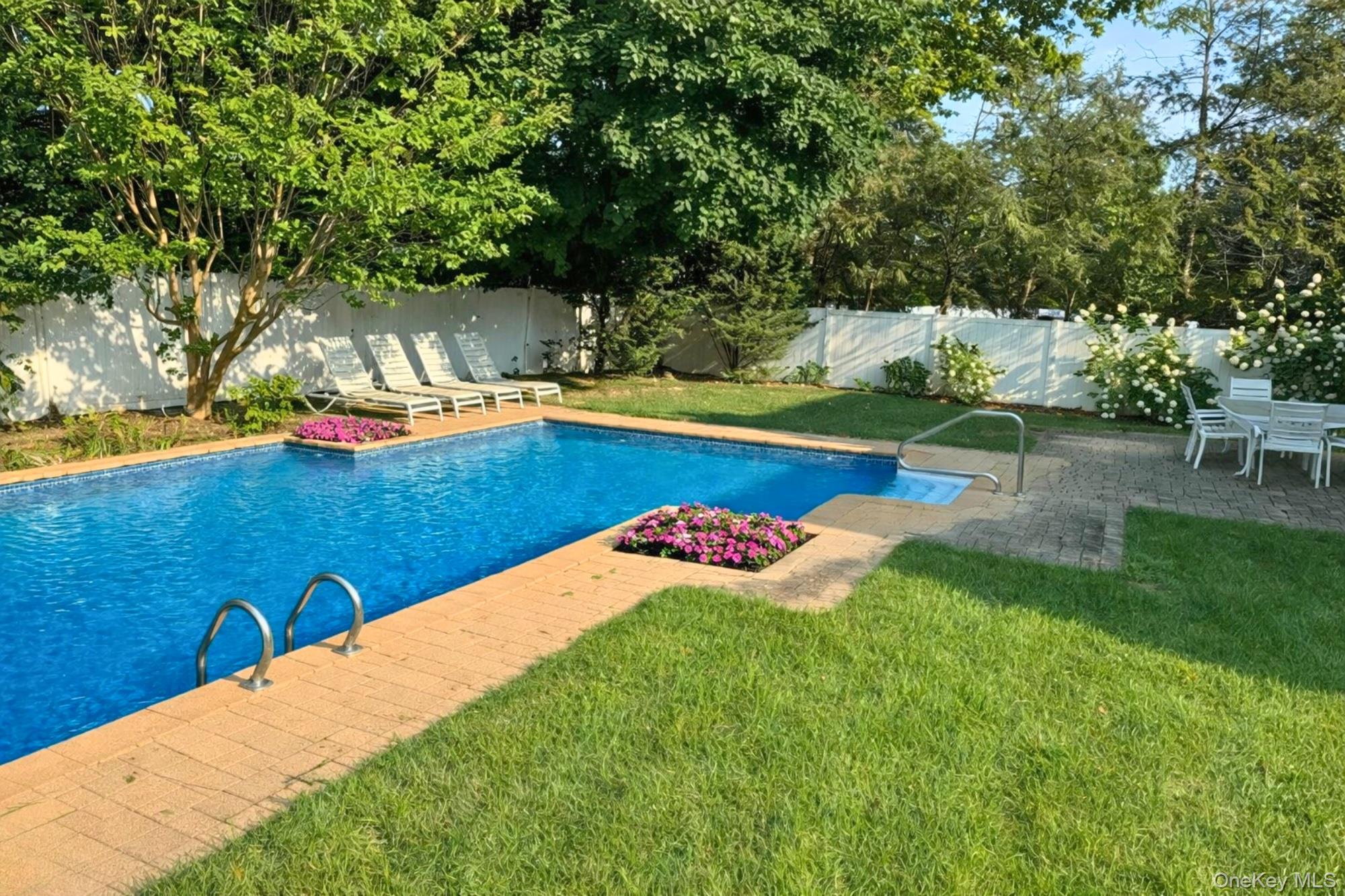 22 Delaware Avenue Jericho, NY 11753 - Photo 32 of 35 a view of a backyard with table and chairs potted plants and large tree