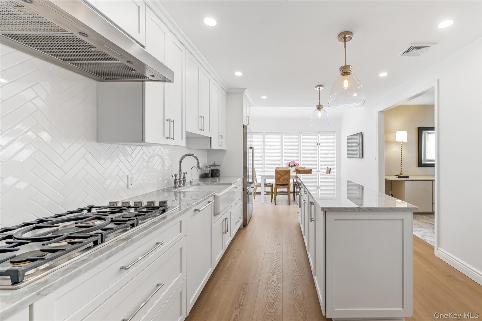 22 Delaware Avenue Jericho, NY 11753 - Photo 5 of 35 a kitchen with white cabinets and appliances