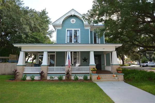 a view of a house with a yard porch and sitting area