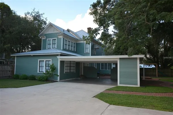 a living room with furniture and a book shelf