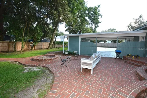 a kitchen with stainless steel appliances granite countertop a refrigerator microwave and wooden floor