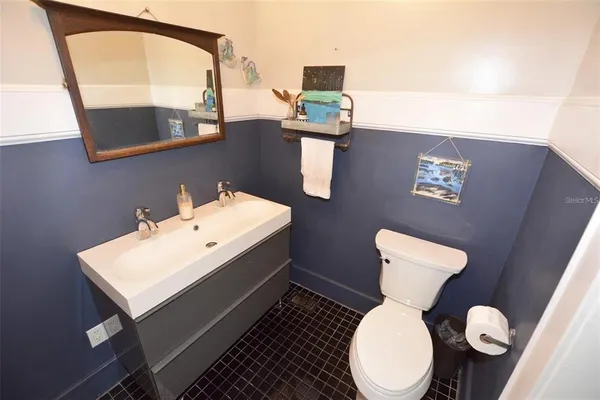 a bathroom with a toilet sink and mirror
