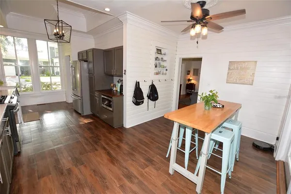 a view of a room with wooden floor and furniture
