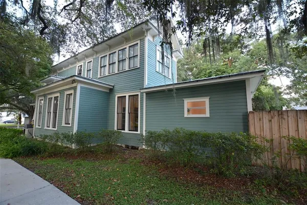 a balcony with couple of chairs and a couch