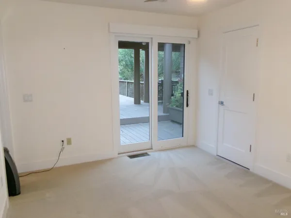 an empty room with sliding glass door