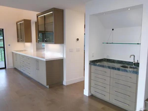 a bathroom with a granite countertop sink and a mirror
