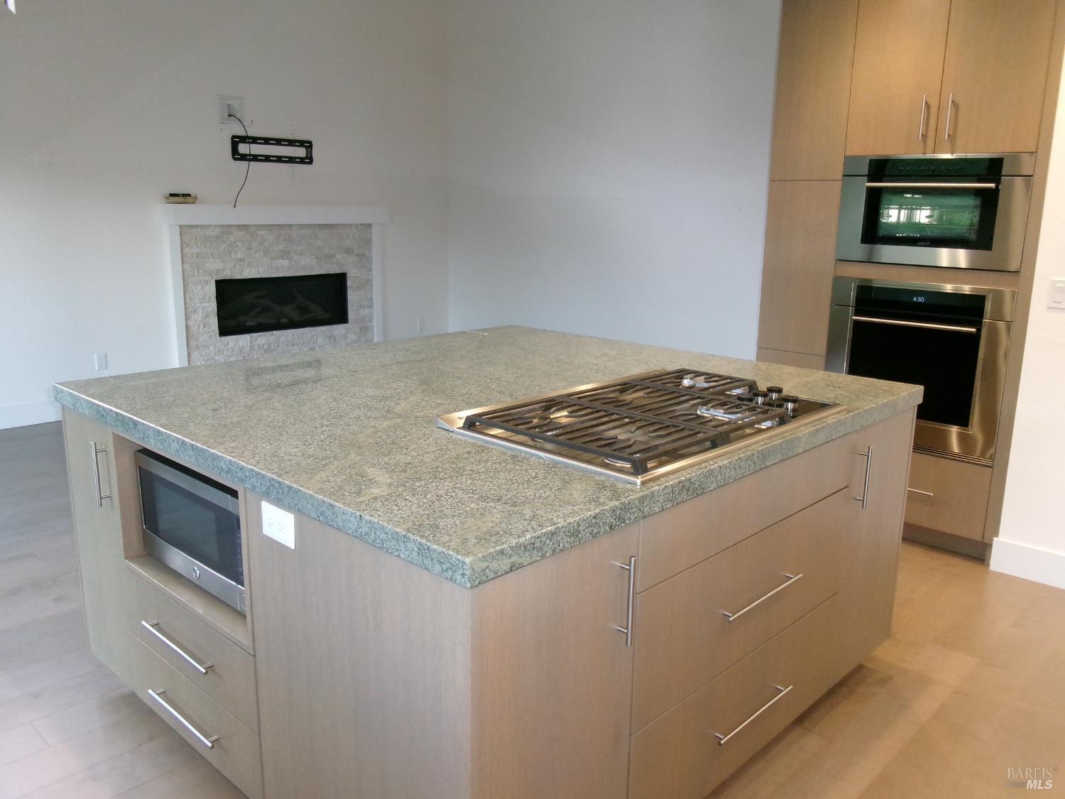 6416 Timber Springs Court Santa Rosa, CA 95409 - Photo 9 of 27 a kitchen with granite countertop a stove oven and a refrigerator