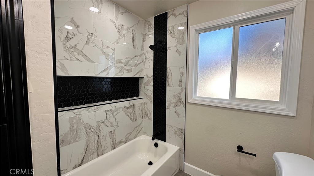 2404 Miller Avenue Modesto, CA 95354 - Photo 11 of 15 a bathroom with a bathtub and a shower