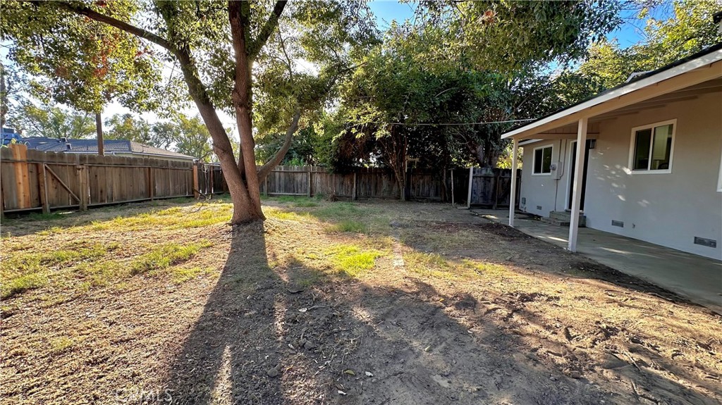 2404 Miller Avenue Modesto, CA 95354 - Photo 15 of 15 a view of a yard with wooden fence and a large tree