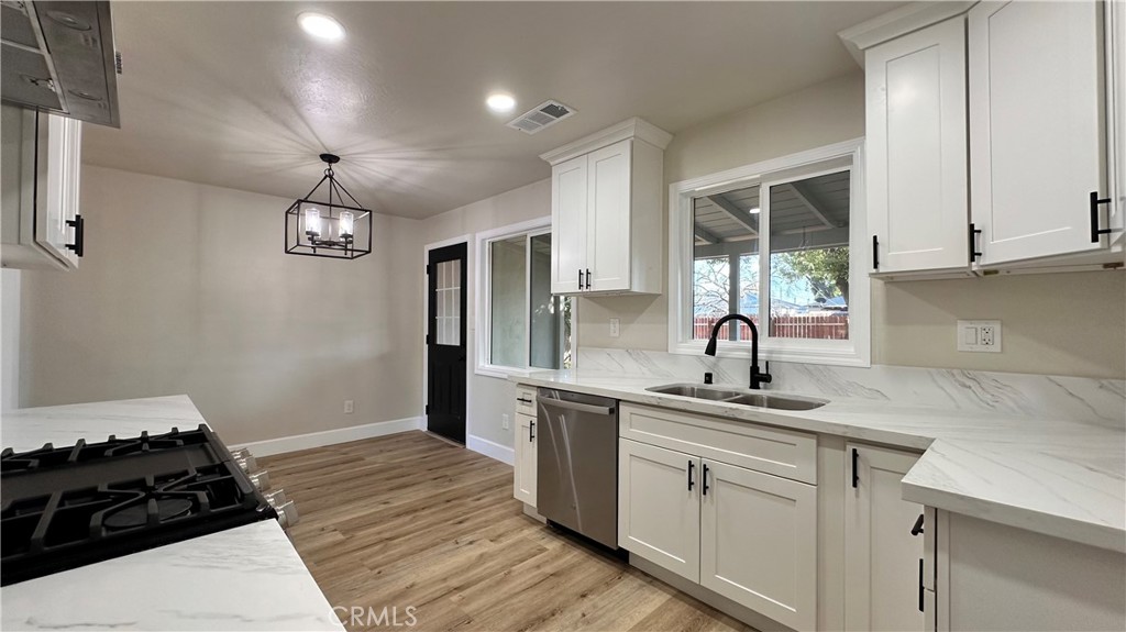 2404 Miller Avenue Modesto, CA 95354 - Photo 7 of 15 a kitchen with a sink stove and cabinets