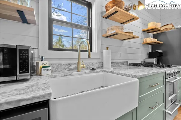 a kitchen with stainless steel appliances granite countertop a sink and a stove