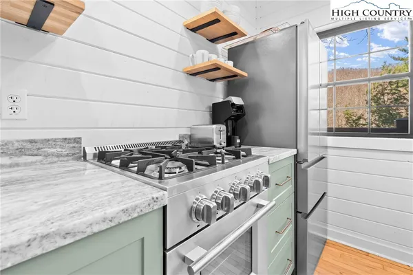 a stove top oven sitting inside of a kitchen